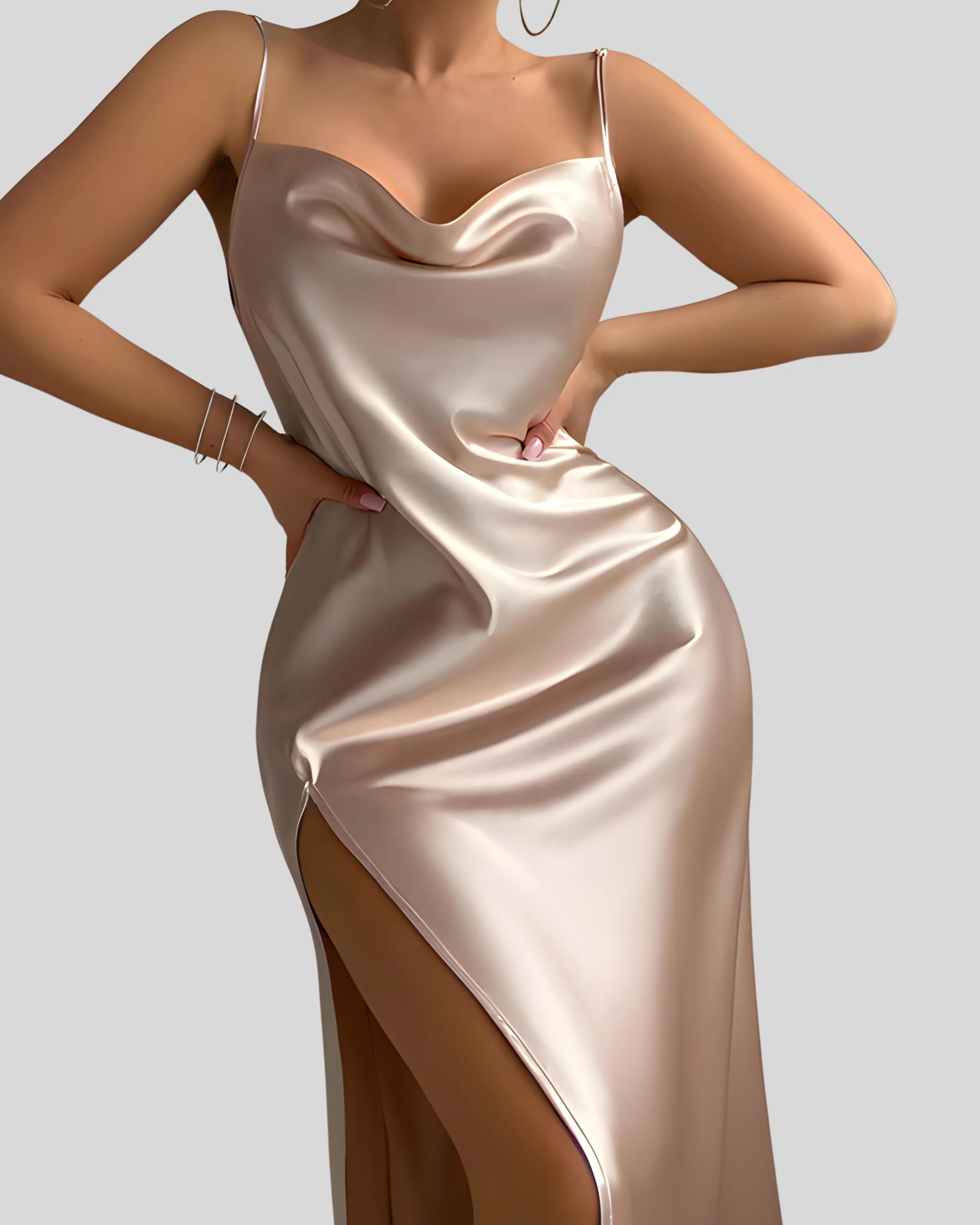 Woman wearing a champagne-colored satin slip dress with spaghetti straps and thigh-high slit, styled with bracelets and hoop earrings