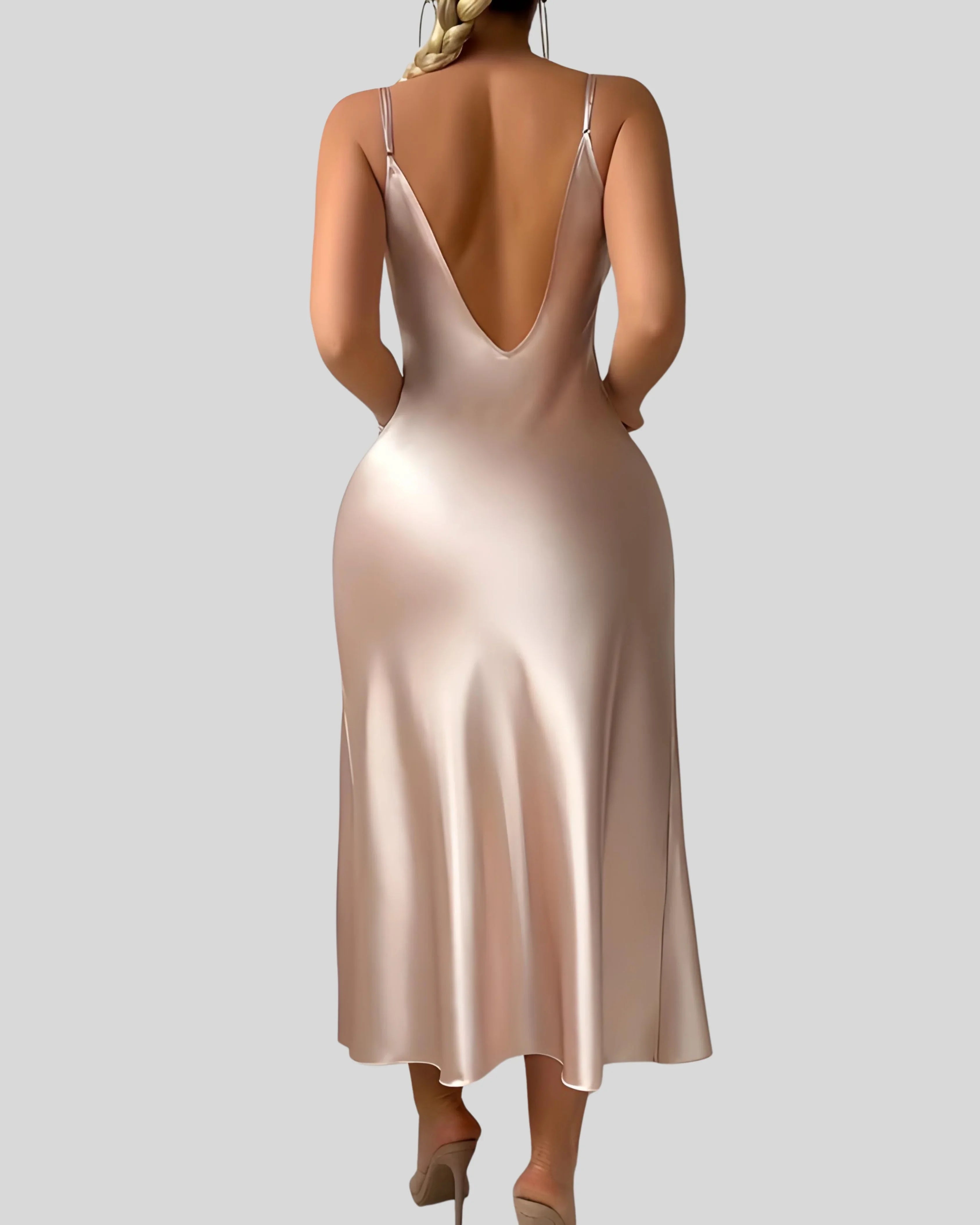 Woman wearing a champagne-colored satin slip dress with spaghetti straps and thigh-high slit, styled with bracelets and hoop earrings